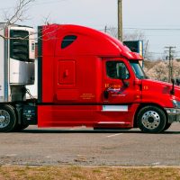 red and white truck on road during daytime
